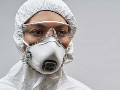 A physician wearing a white face mask as part of COVID-19 safety protocols