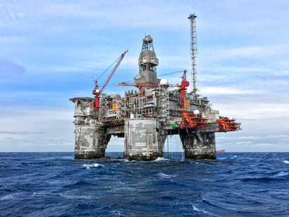 A massive drilling installation at sea, representing humanity’s relentless pursuit of energy security