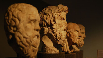 A photo of four philosophical busts, featuring Aristotle and other great thinkers, capturing the essence of timeless wisdom