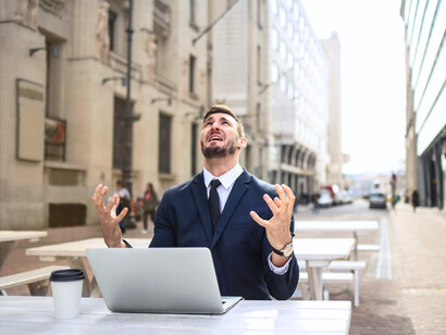 A man in formals seemingly stressed about work, depicting how the pressures of the corporate world can take a toll on individuals, making them turn to unhealthy coping mechanisms