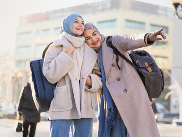 Two women navigating a new destination together, symbolising how educational exchanges encourage openness, understanding, and shared discovery