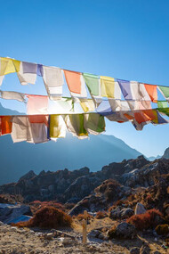 Amidst the awe-inspiring backdrop of the Khumbu region of the Himalayas, in northeastern Nepal on the Nepalese side of Mount Everest, prayer flags flutter serenely, carrying hopes and blessings across the thin, invigorating air