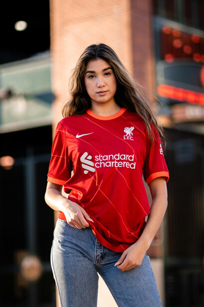 Woman showing support for Liverpool FC in a football jersey