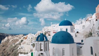 View of Santorini, Greece, with iconic white houses and blue-domed churches