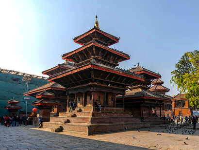 People sightseeing at the facade of a Buddhist temple in Patan, Nepal