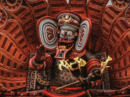 Theyyam, a vibrant Hindu ritual featuring red-and-white deities, is practiced in the North Malabar region of Kerala and parts of Karnataka