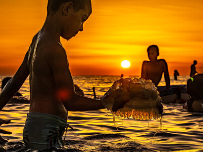 The fiery hues of a sunset Kerkennah, Tunisia, bathe the shoreline in a warm, meditative glow, reflecting the timeless rhythm of island life, image taken by Pierre Gassin