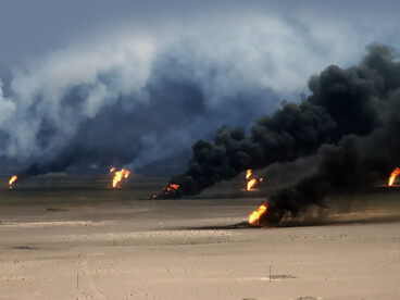 Oil well fires burn outside Kuwait City after Iraqi forces set them ablaze before being driven from the region by coalition forces during Operation Desert Storm