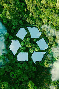 An untouched natural landscape features a lake intricately shaped like a recycling sign, serving as an ecological metaphor for waste management, sustainable living, and prudent resource use