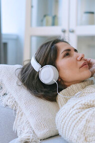 With headphones enveloping her ears, she experiences a symphony of feelings, allowing the melodies to express what words cannot