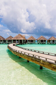 Stunning overwater bungalows perched above the crystal-clear waters of the Maldives