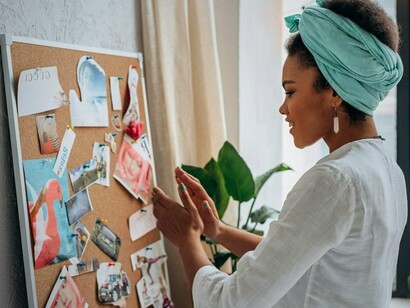 A woman crafting a vision board, reflecting the practice of aligning actions with values