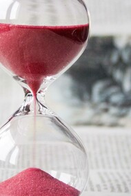 The hour glass symbolizing that our time is slipping away