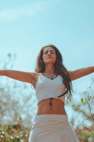 In the serene morning light, a yogini finds balance amidst ancient ruins, blending tradition with contemporary wellness practices
