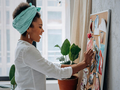 A woman designing a vision board, highlighting the power of visualizing meaningful direction