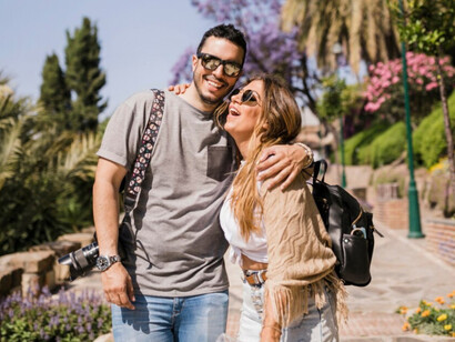 A couple hugging and smiling while sightseeing in Thailand