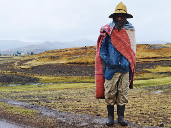 A Lesotho herder wears a Basotho blanket, a covering commonly worn, which has become a national symbol