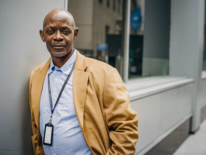 Confident black businessman studying documents outdoors, symbolizing innovation and leadership