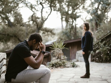 During a breakup, a couple appears visibly upset and filled with despair