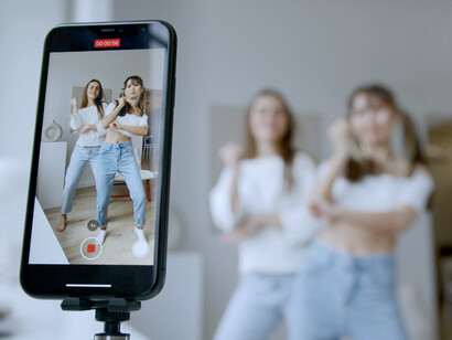 A duo doing a TikTok dance, reflecting how social media has become a platform for creative expression and connection