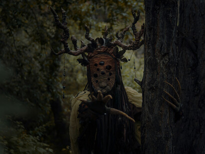 A shadowy figure standing in a dark forest, representing how limited visibility and fear give rise to cryptid legends