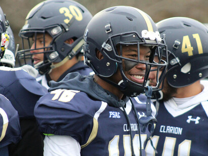 A group of football players in a huddle before the game