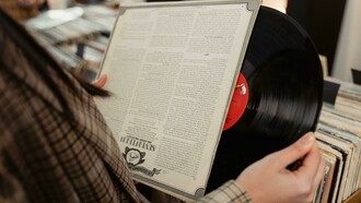 A person looking closely at a vinyl record