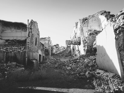 The hollow shells of buildings stand as silent witnesses to devastation