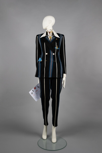 Striped high-waist trouser suit with Jacquard Hals blouse, rose print neckerchief and bolo tie. Café society, SS 1994. © The Bowes Museum, County Durham. Photography by Claire Collinson