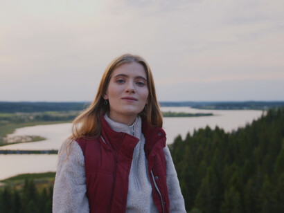 As she smiles at the camera, she embraces the serenity of the mountain, knowing that a balanced lifestyle supports her happiness and mental health