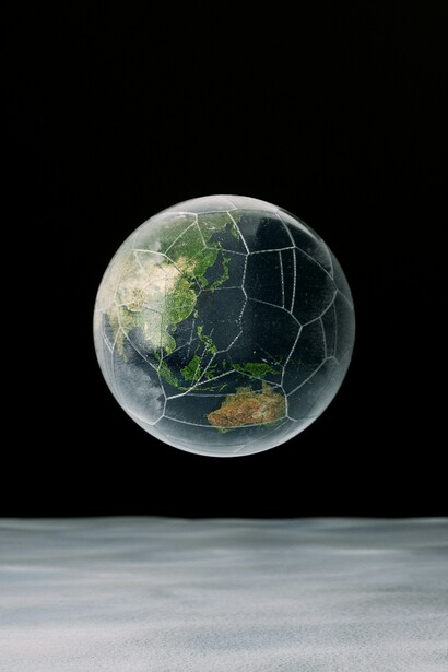 A world that is seemingly intact but filled with cracks, hinting at the divided world as the competition between geopolitical blocs intensifies
