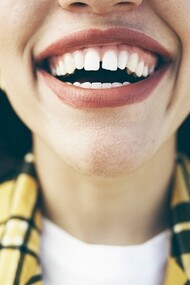A happy woman smiling with healthy teeth