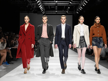 On the catwalk, models present genderless fashion, highlighting its growing influence in the fashion industry