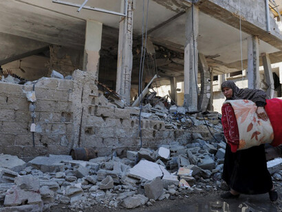 Palestinians search the rubble of their homes destroyed by Israeli strikes in the northern Gaza Strip