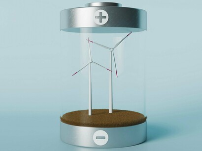 A transparent battery casing holds two miniature wind turbines on a patch of brown ground, visually symbolizing wind energy as a power source and its potential storage