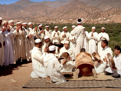 A group of men taking part in the Ahwach Dance in Aoulouz, Taroudant, showcasing their traditional Moroccan culture