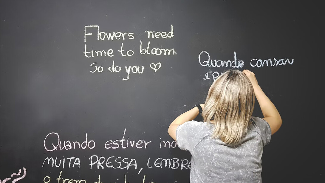 A student writing on the chalkboard