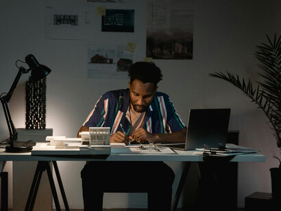 Man sitting at his desk appearing tired and overworked