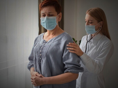A warm-hearted female doctor interacting with an elderly patient facing a chronic illness, contemplating the lived experience of illness, existential perspectives, and the principles of medical ethics