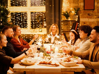 A family enjoying a festive Christmas spread, reflecting the importance of community and sharing during the season