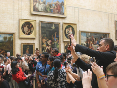 Visitors viewing the Mona Lisa at the Louvre Museum in Paris, France