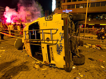 An overturned car, marked with graffiti, amid the protests in Türkiye, 2013