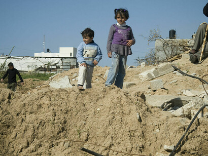 Children surrounded by ruins in Gaza, witnessing the devastation in Palestine