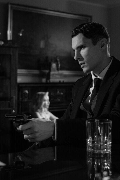 A monochrome photograph of men sitting at a bar counter