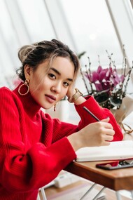 A woman writing in her diary, representing the quiet rebellion of self-expression