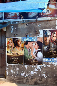 A building covered with colorful movie posters