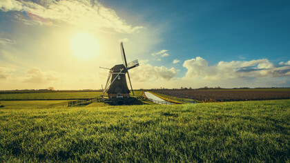 Vintage black windmill at sunset in Uithuizermeeden, Groningen, Netherlands 