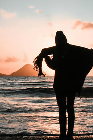 Silhouette of woman standing on the seashore
