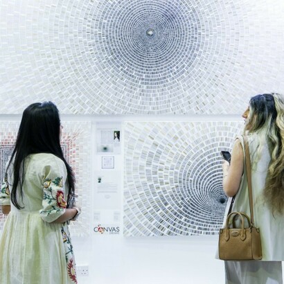 Visitors engage directly with emerging artists across vibrant exhibition booths, World Art Dubai, Dubai, United Arab Emirates