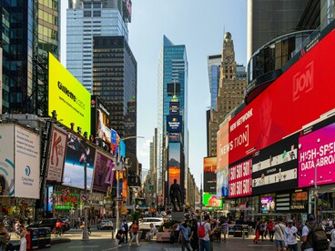 Large digital screens and crowds filling Times Square in New York City, USA